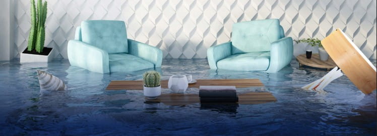 Flooded living room with chairs, table, and décor partially submerged in water, representing water damage and flood risk.